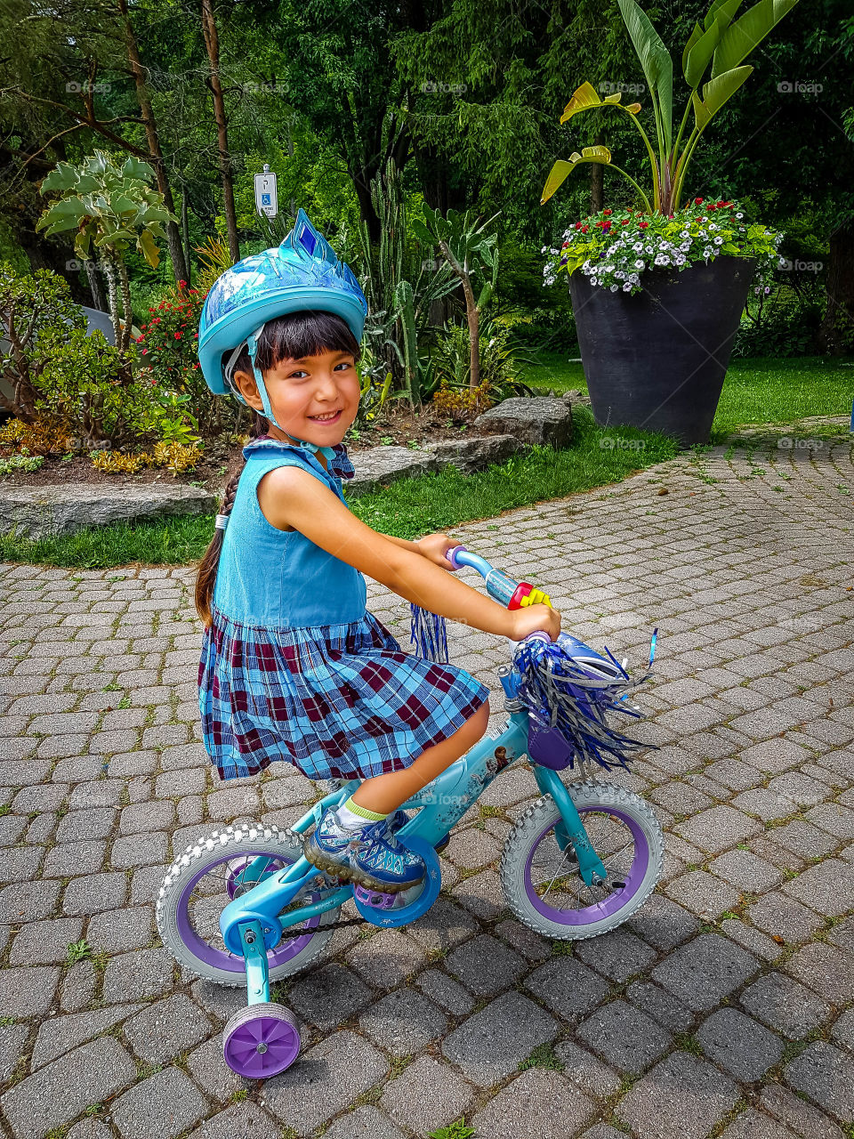 Cute little girl is riding a bike