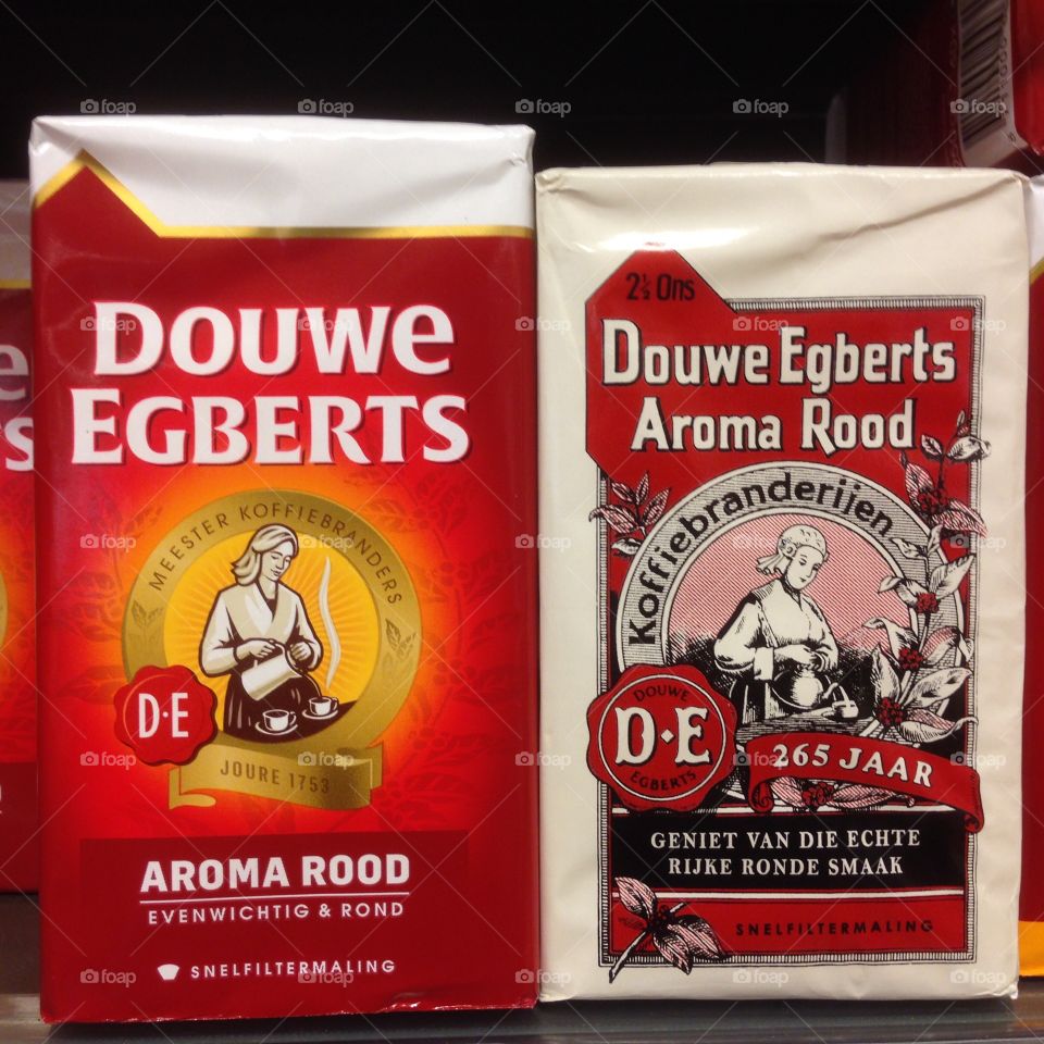 Two packages of Douwe Egberts coffee, a modern and old package design.