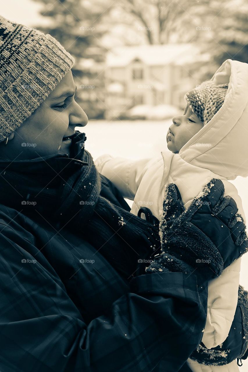 Mother and daughter out in the snow, enjoying the first snow, snowy weather with newborn girl, mother and daughter tender moments, loving moments with baby