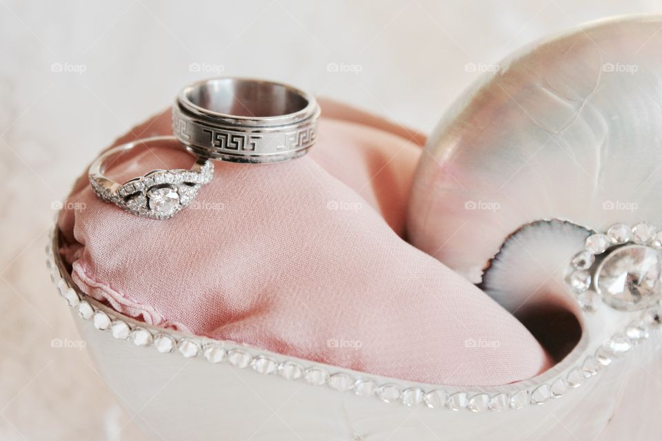 These are our gorgeous wedding rings on a shell ring holder 