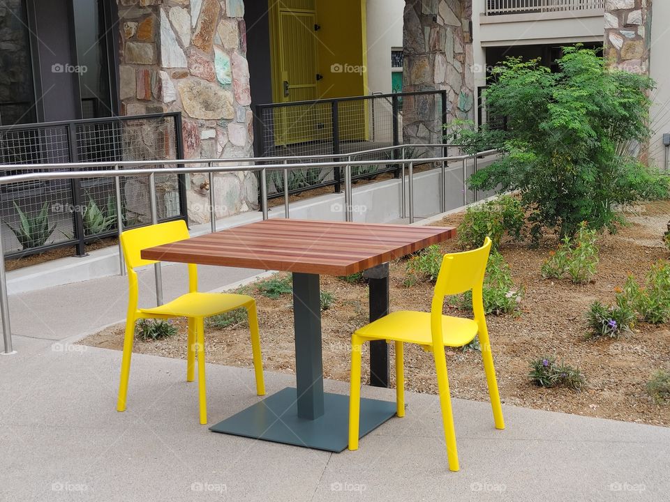 Yellow chairs and butcherblock table