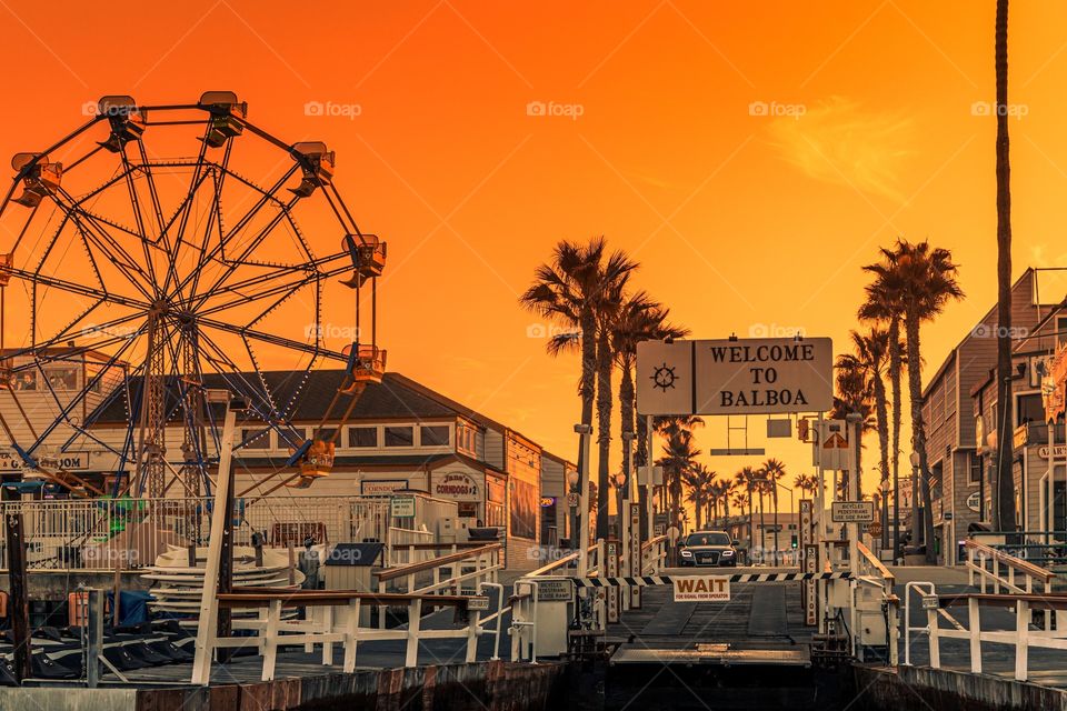 The sunset lit ferry landing at Balboa Island, Newport Beach, Orange County, California, USA.  