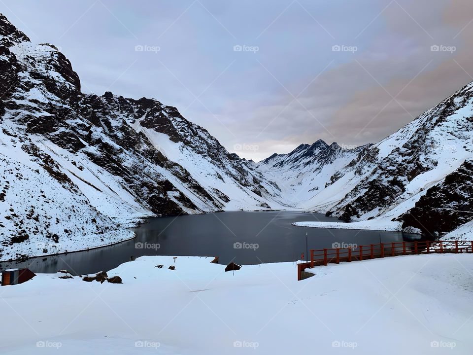 Frozen lake between snowy mountains