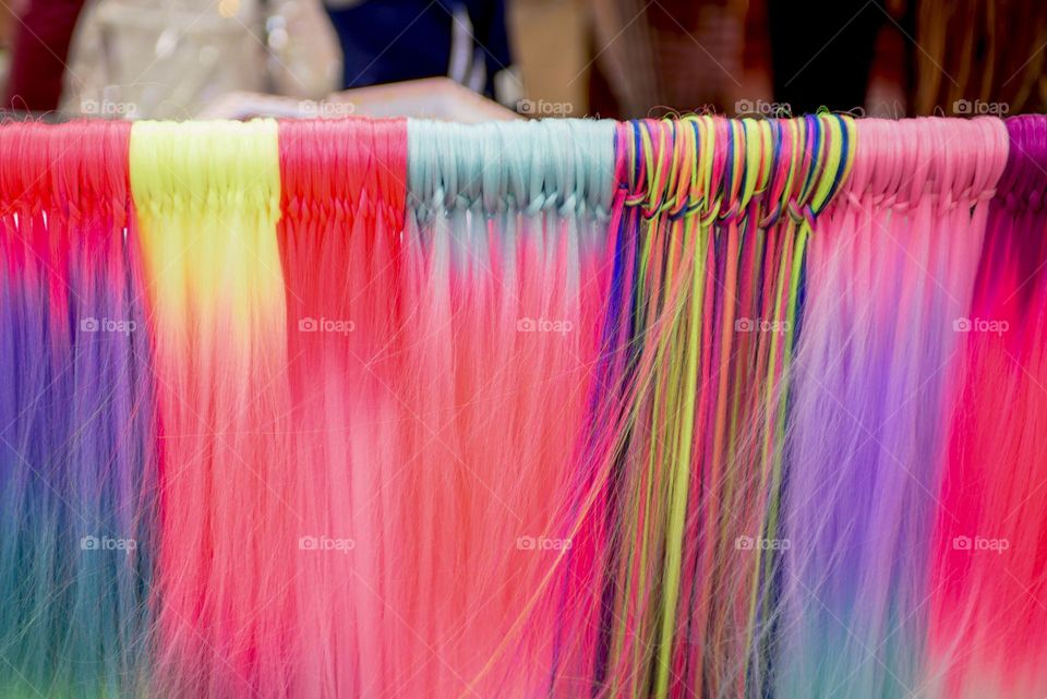 Multi-colored beautiful artificial hair in a beauty salon