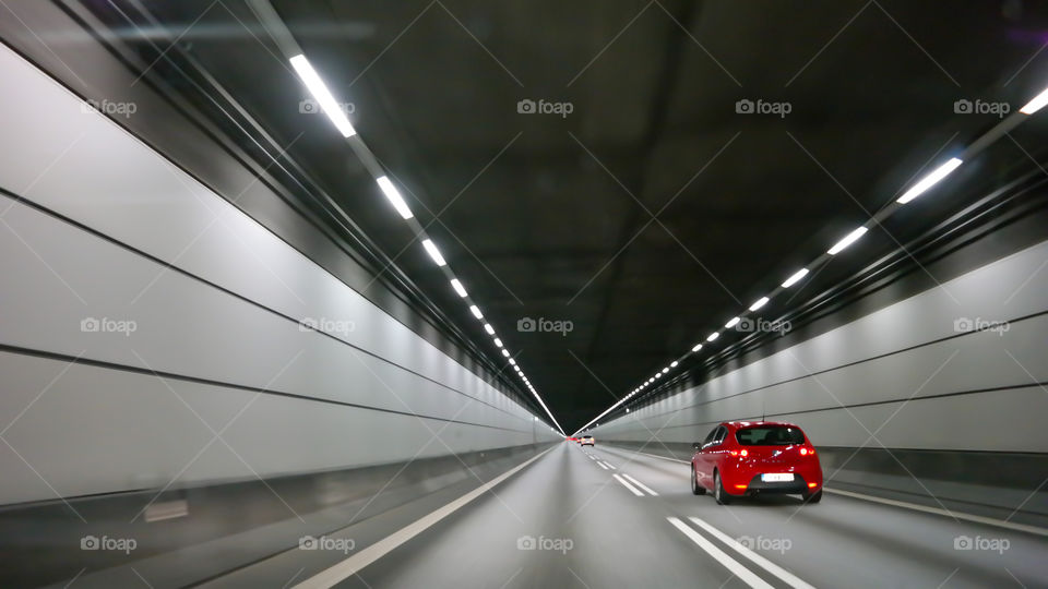 Red car on the grey background of the Oresund tunnel between Sweden and Denmark 