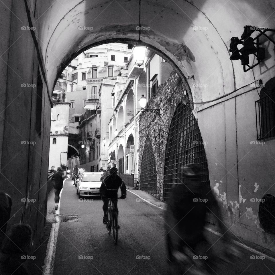 Amalfi, Italy, Napoli region. Bicycle riders going across the tunnel 