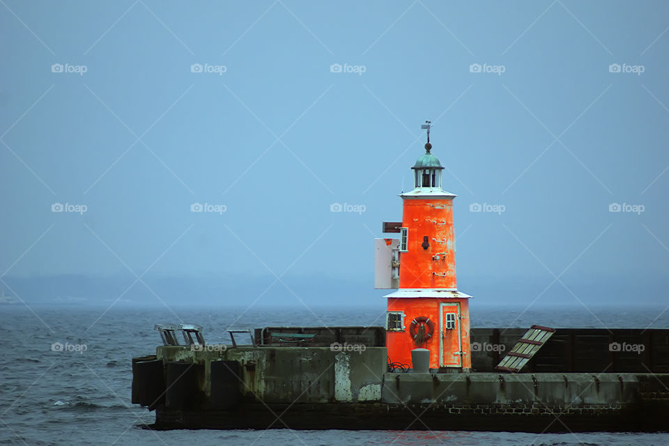 Orange lighthouse on the port, Denmark