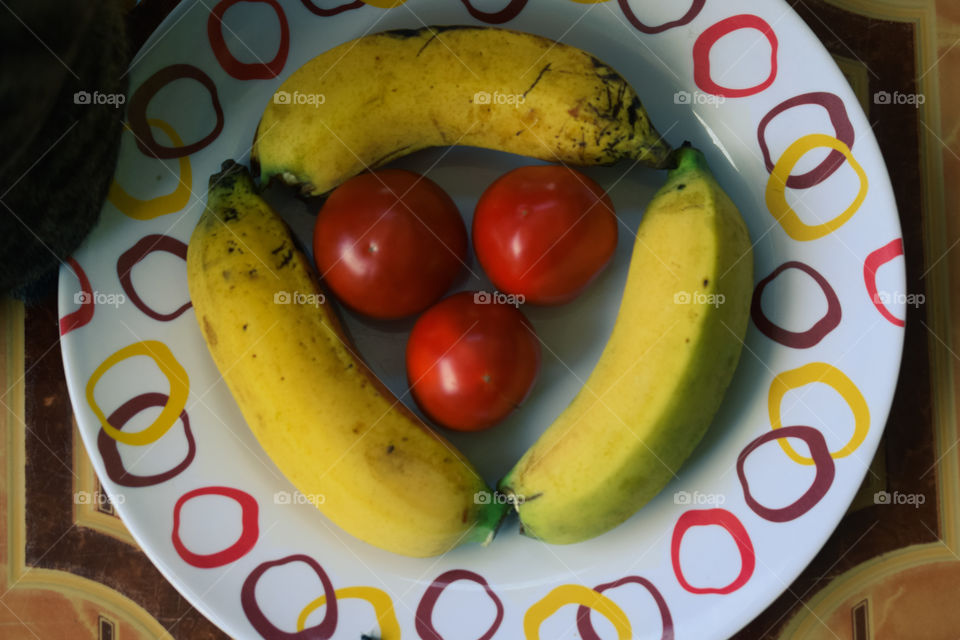 tomatoes and bananas on a plate