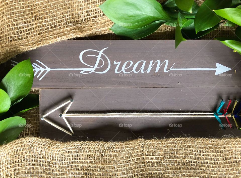 arrow  dream on wooden background and burlap background