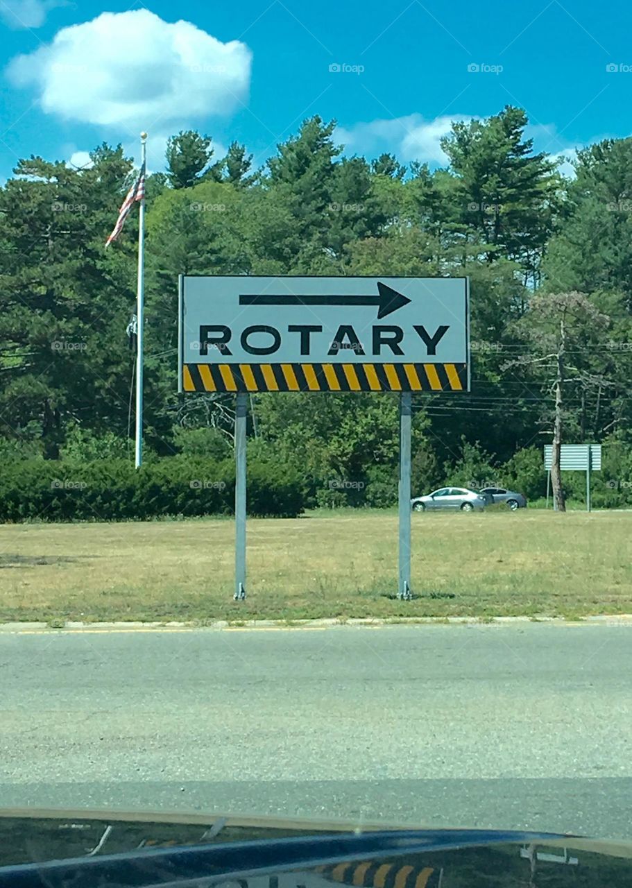 Rectangular sign at a ROTARY used to keep traffic flowing safely. Some countries call these "RoundAbouts".