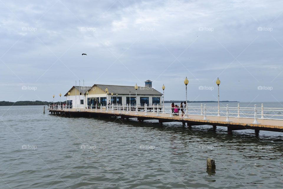 View of a dock with a house on the sea