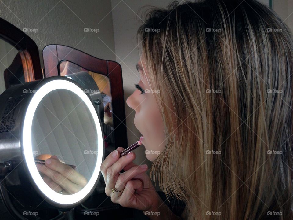 Woman applying cosmetics
 