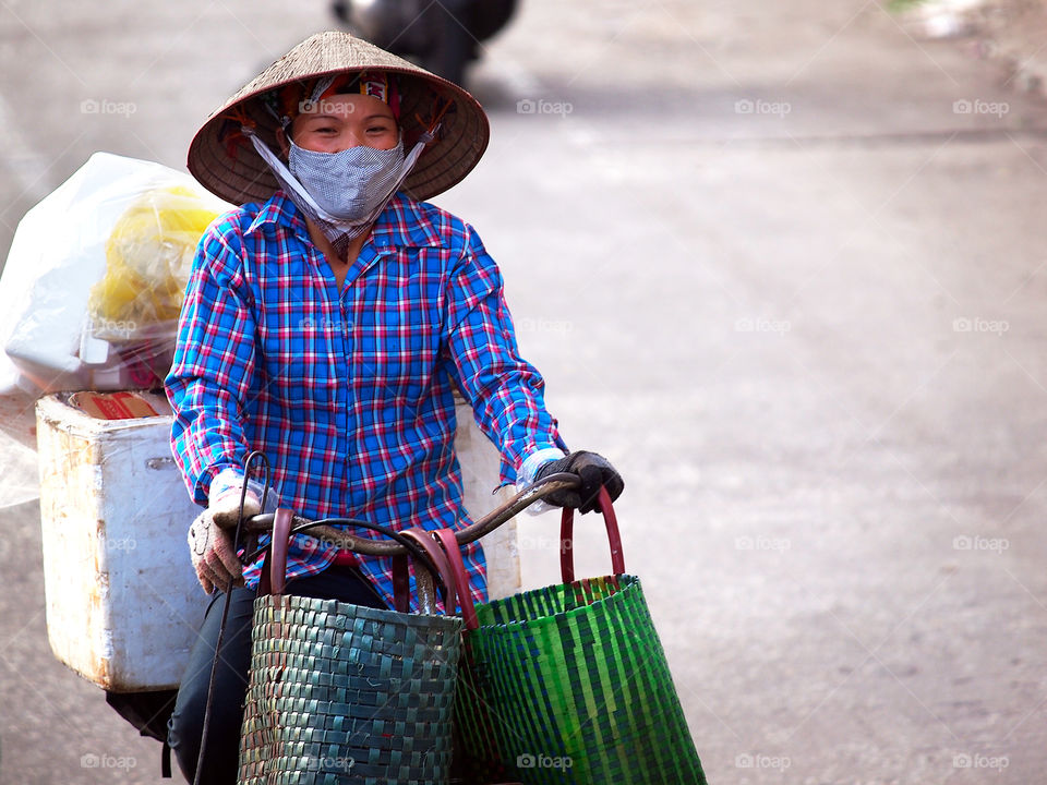 The vietnamese woman on bicycle