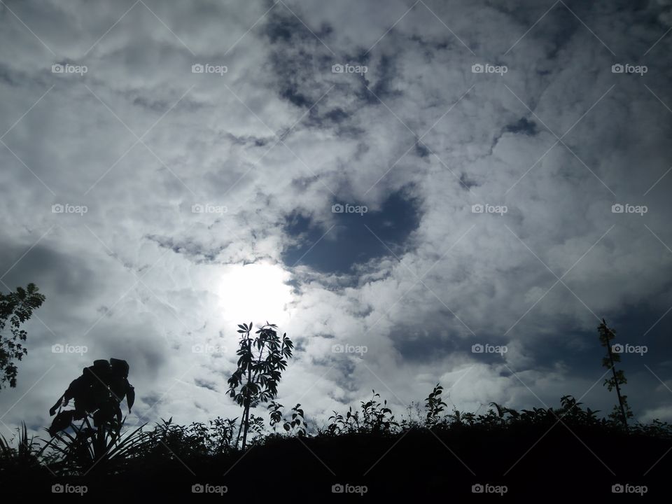 sun comes through dark clouds