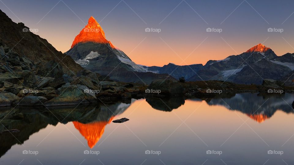 the red tip of the mountains from the break of the rising dawn or the sun sinks into the other side of the world
