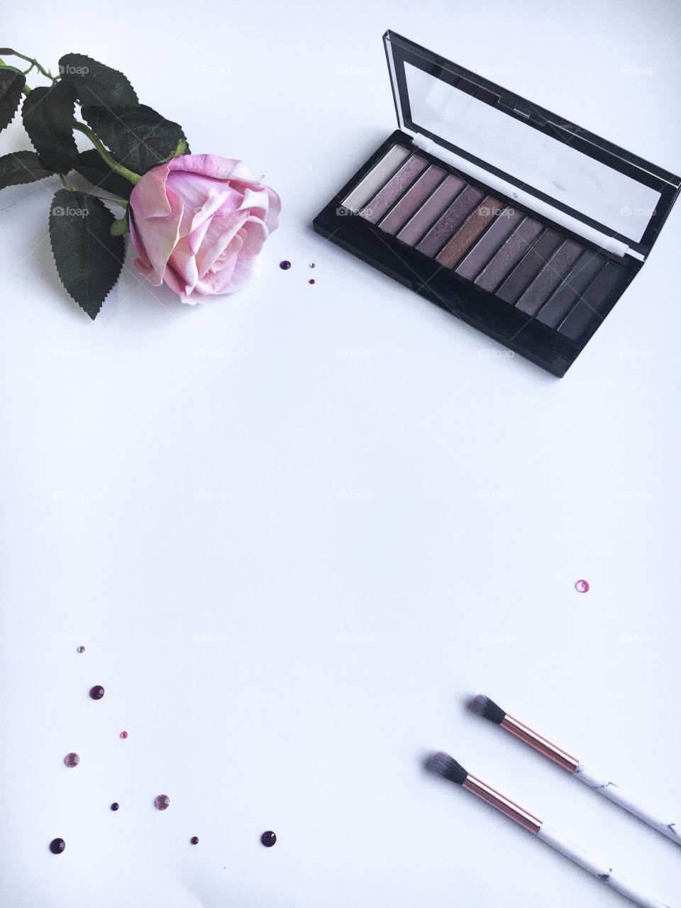 Makeup flat lay on a white background.