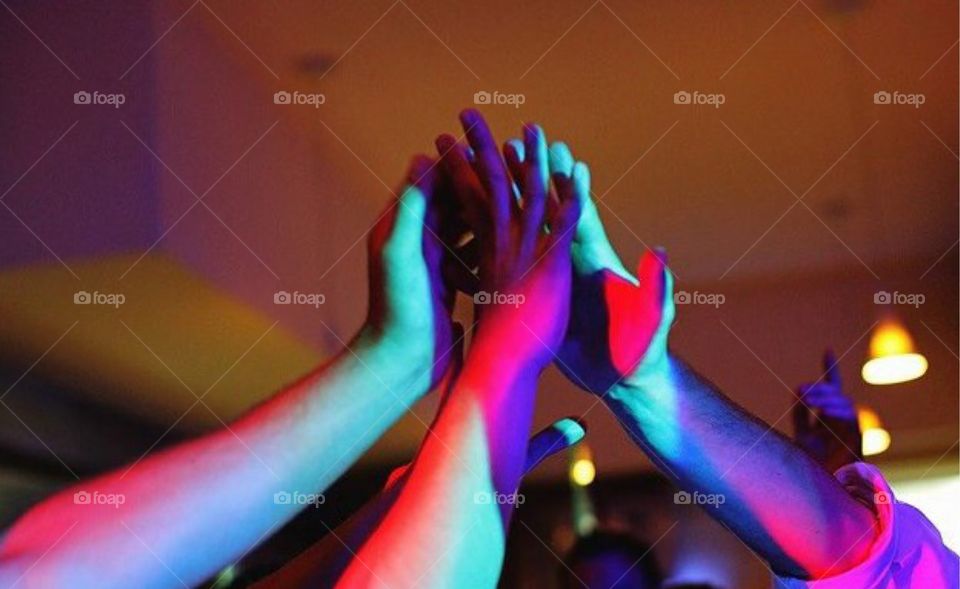 Hands in the air touching 