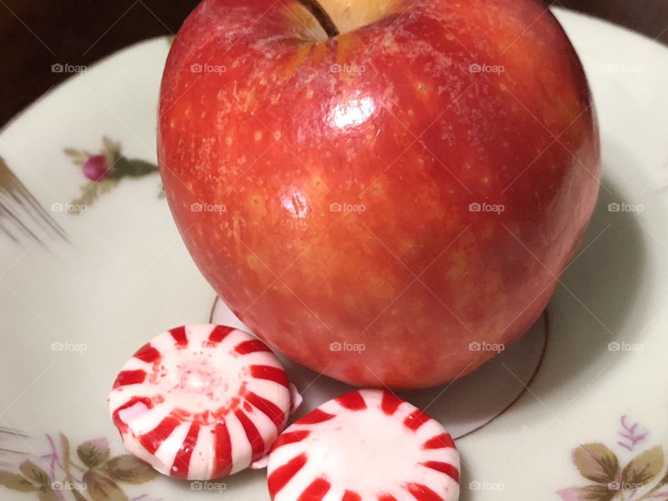 Pinwheel peppermints and a juicy red apple