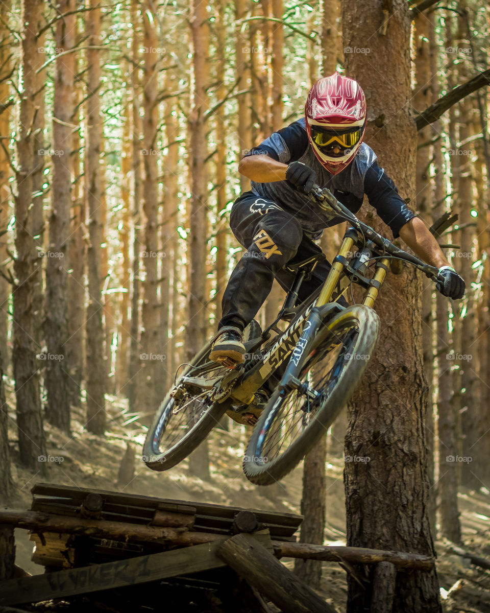 Fast jump in the forest doing downhill