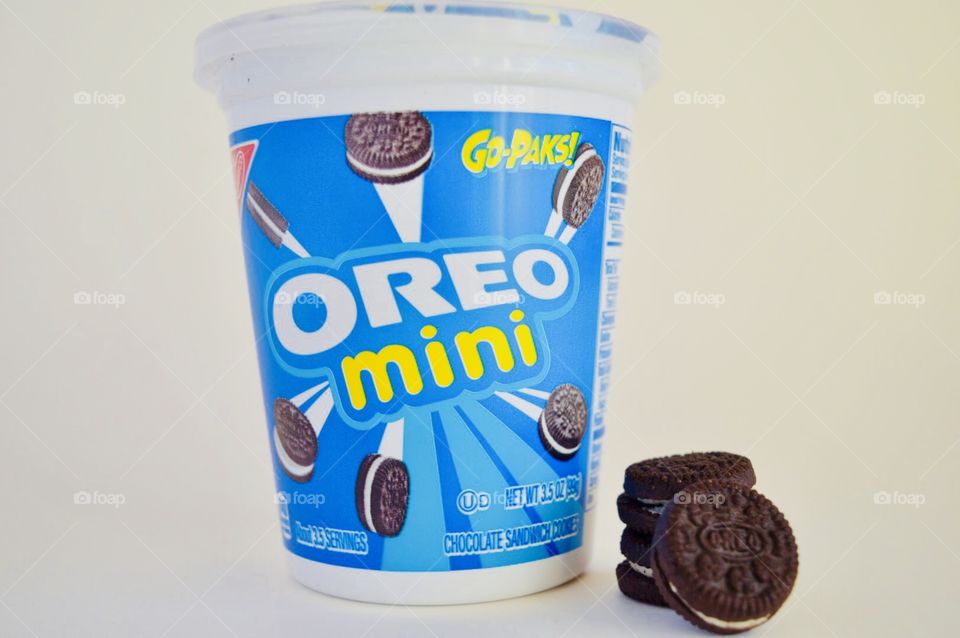 Oreo mini cookies stacked in front of open container 