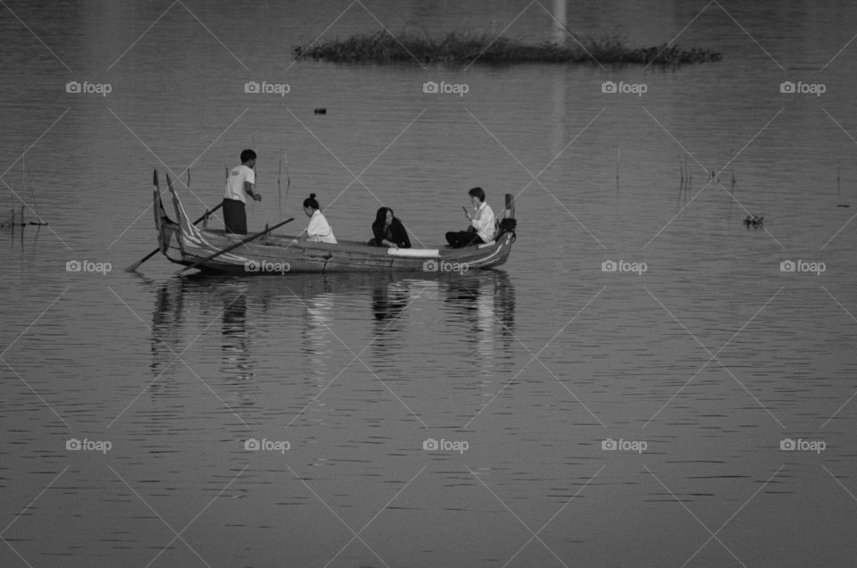 Myanmar guide tourists in boat to see local life at U bein bridge , the most longest wooden bridge in the world