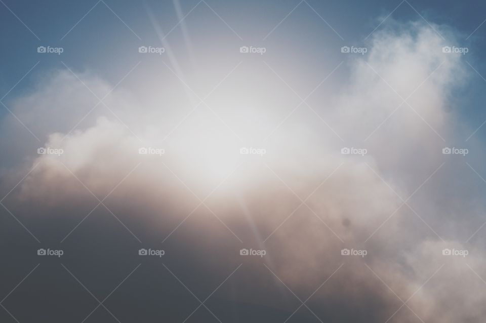 Sun piercing through the clouds at the Masaya Volcano in Nicaragua