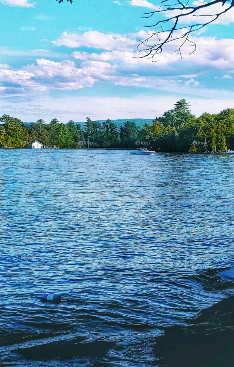 A motorboat passing a Boathouse!