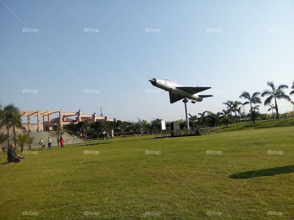 The landscape of a park with an air fighter jet