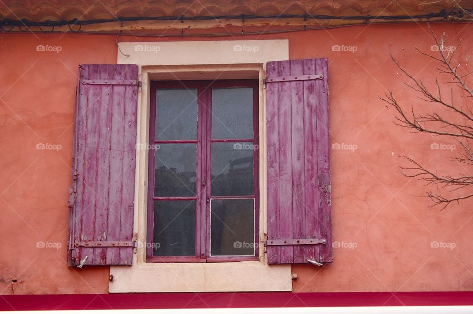 Shades of red . Window in Roussillon, France 