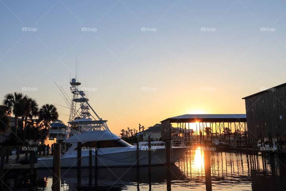 Yacht boat parking at the dockwith sunset