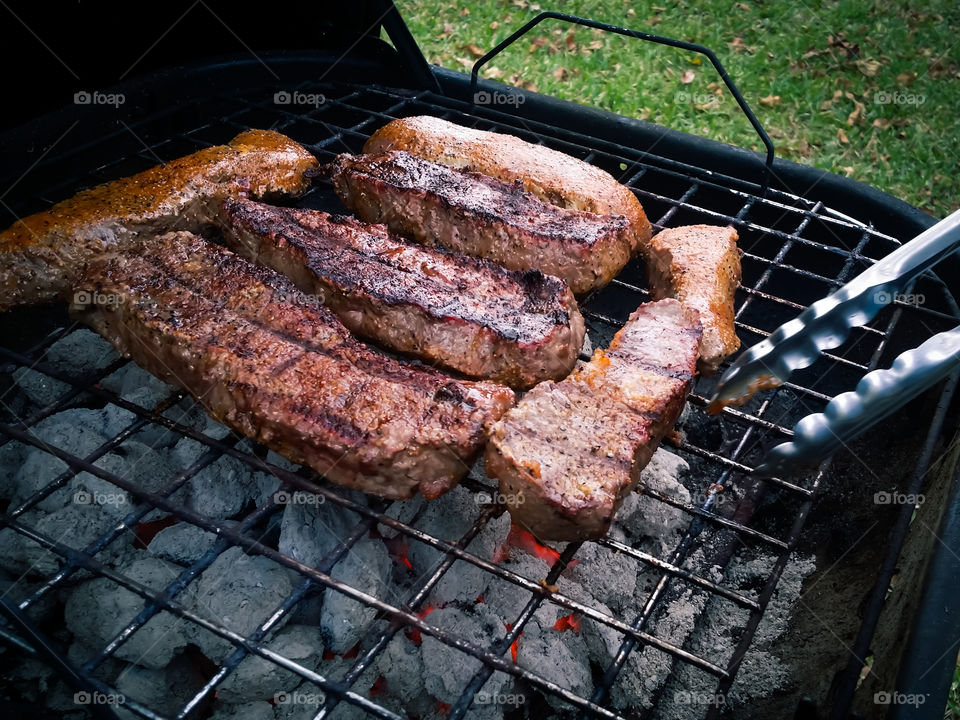 Charcoal Grilling Steaks Closeup