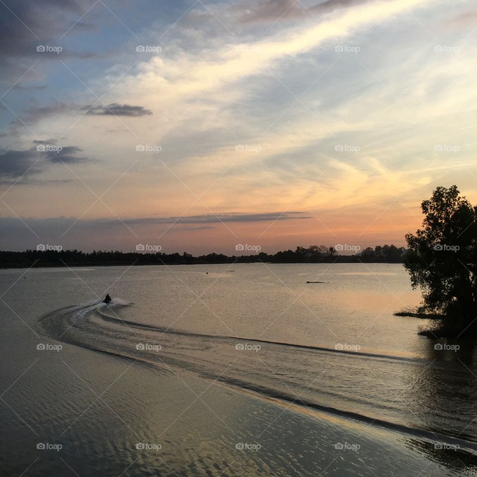 Ride a jet ski while sunset