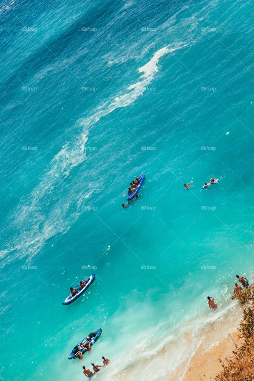 People swimming in the ocean at Lagoa, Algarve, Portugal