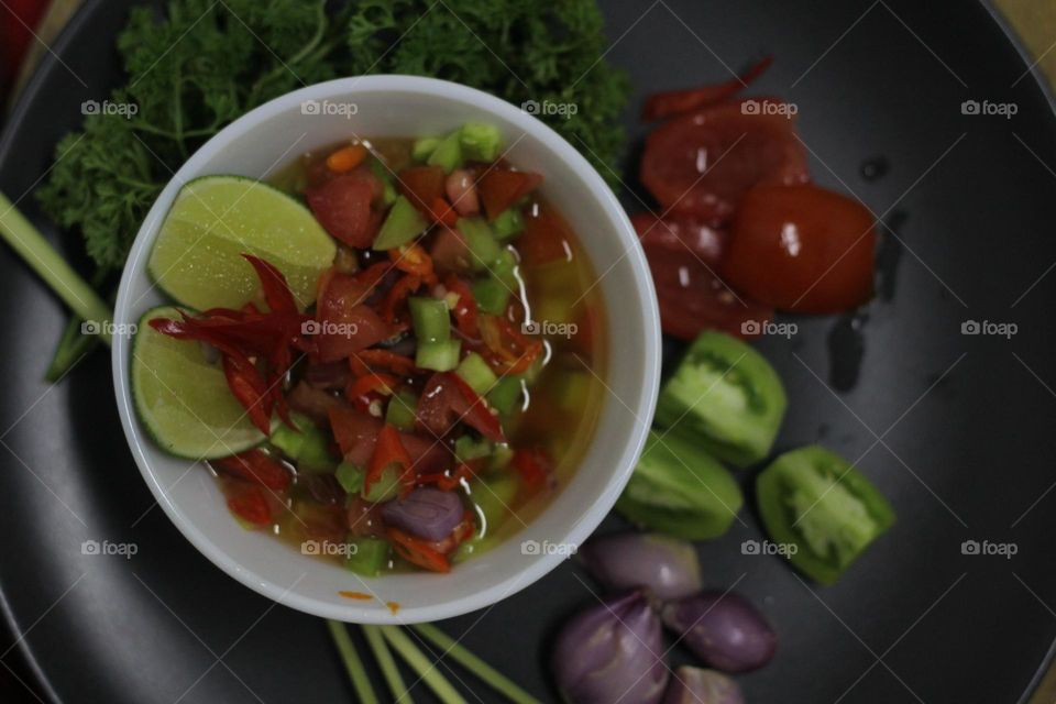 Sambal Dabu typical of Manado, Indonesia.  It is a typical Asian chili sauce mixed with various kinds of herbs and spices.