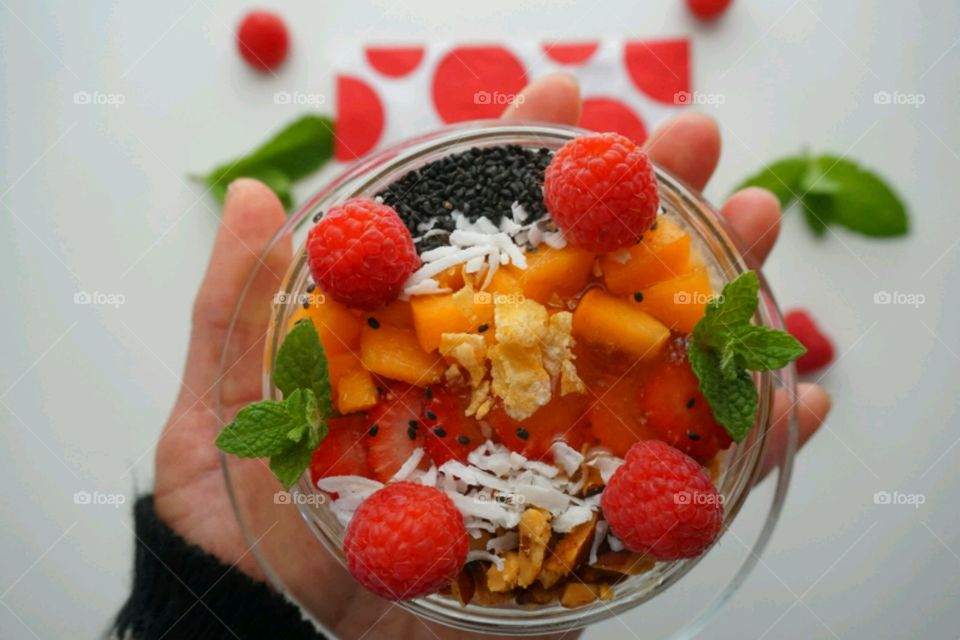 Smoothie fresh fruits bowl - peach, raspberry,  almonds,  strawberries,  coconut,  honey,  seeds and mints