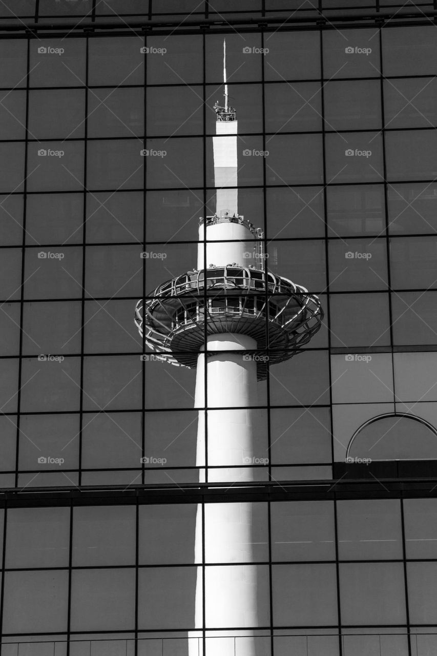 Reflection of Kyoto tower in a glass building