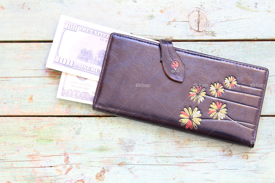 hundred dollars and leather wallet