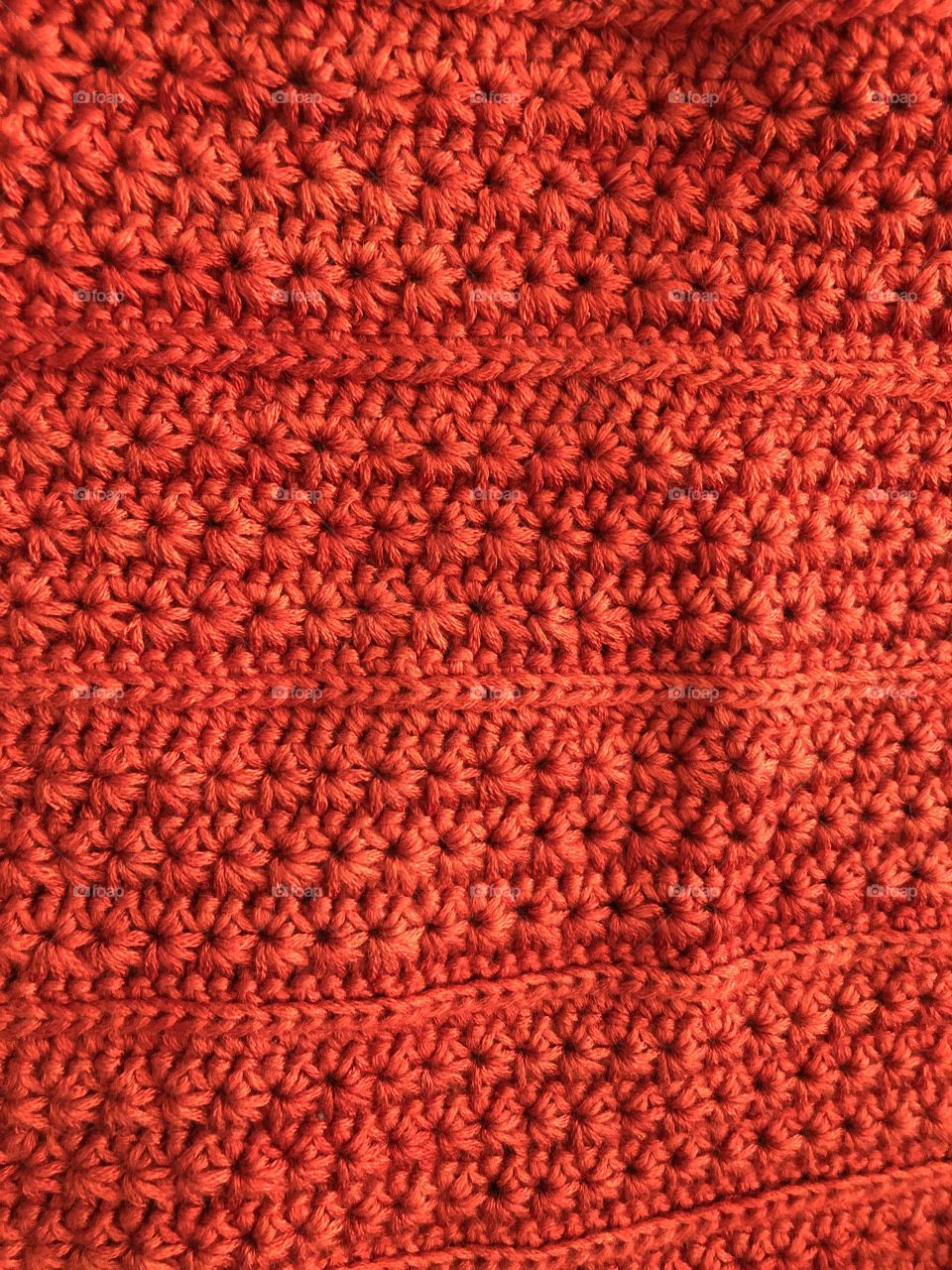 Crocheting a red bamboo wool hat. 