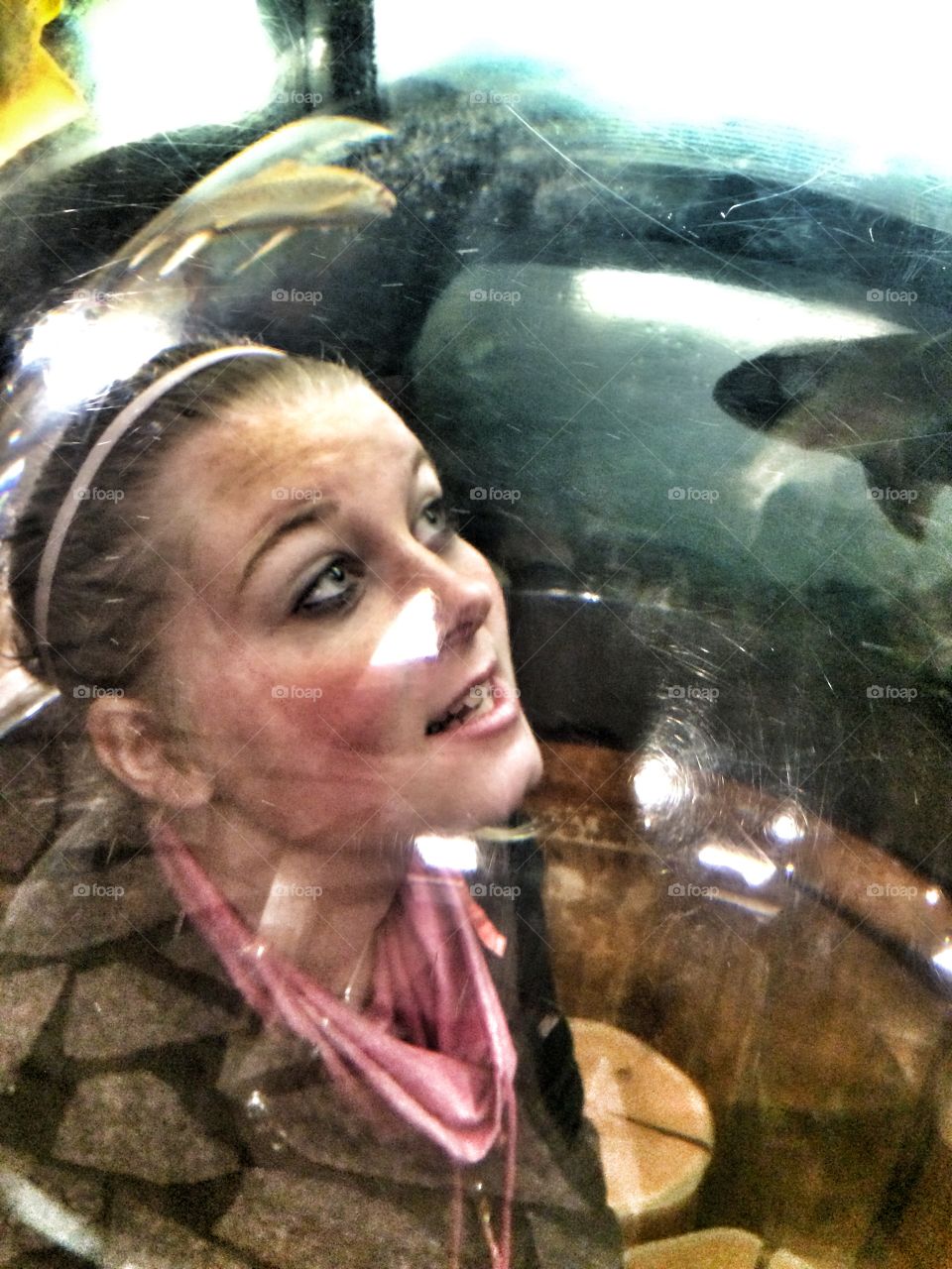 Woman looking at fish in tank