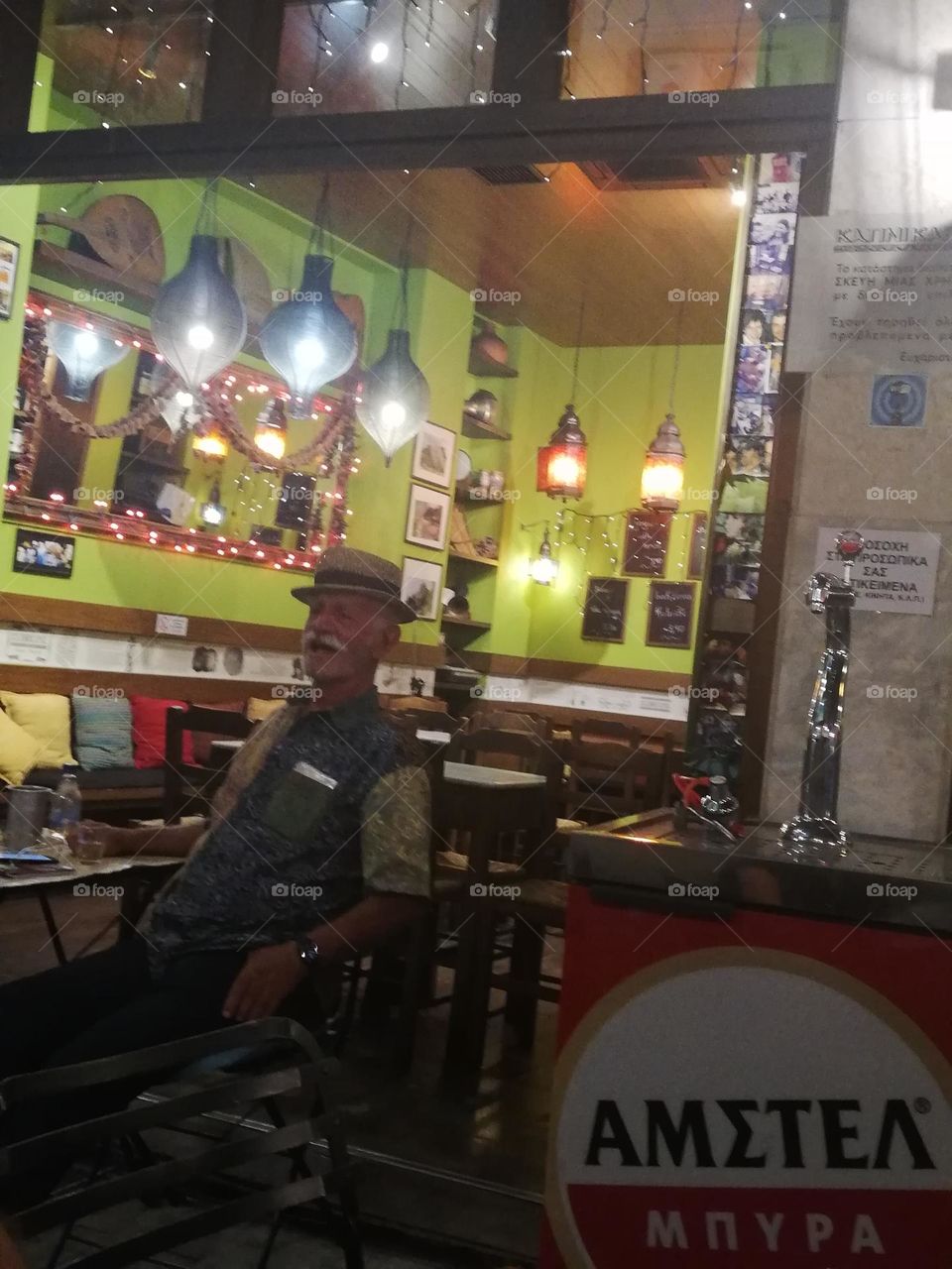 Old man drinking at the pub