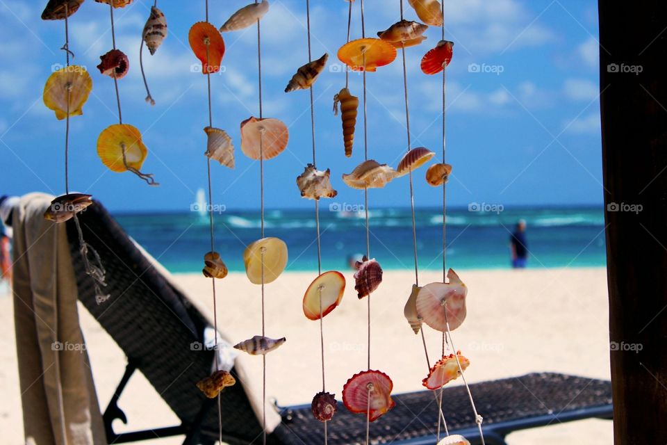 Seashells hanging on the string as a decoration on the beach