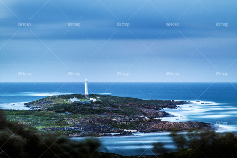 Cape Leeuwin lighthouse dwarfed by giant rocky outcrops on the coast at Augusta in South West Western Australia
