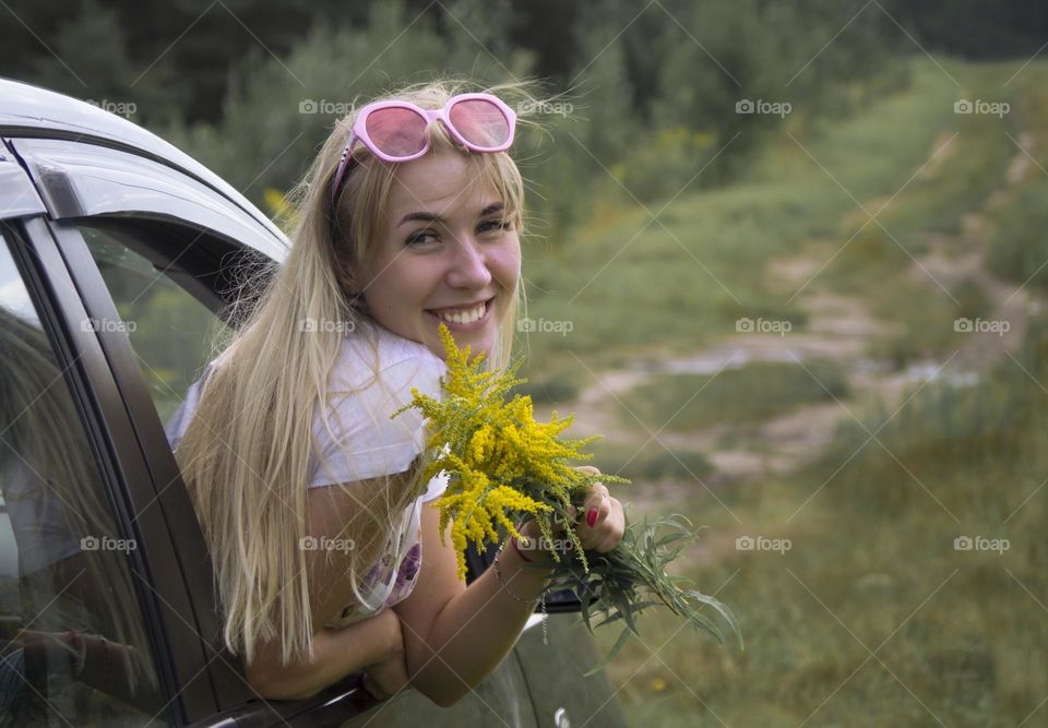 A girl rides in a car on the road