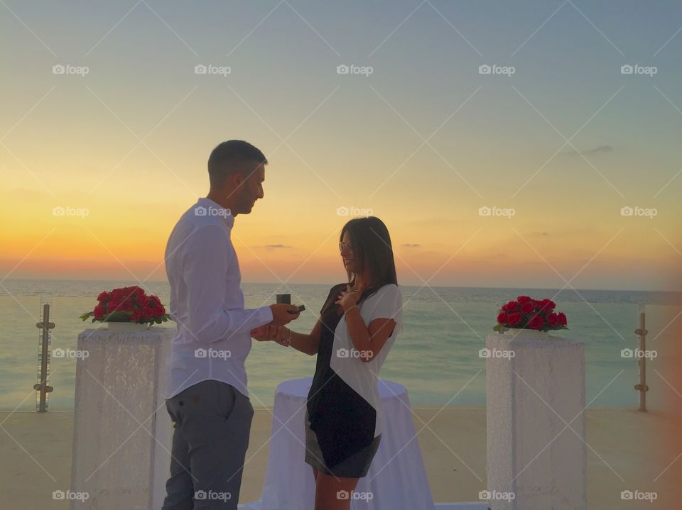 A man proposing his girlfriend at beach