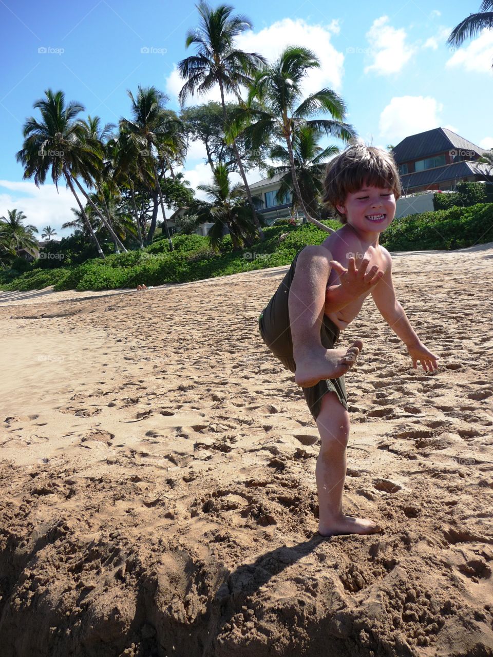 Close-up of boy playing on sand