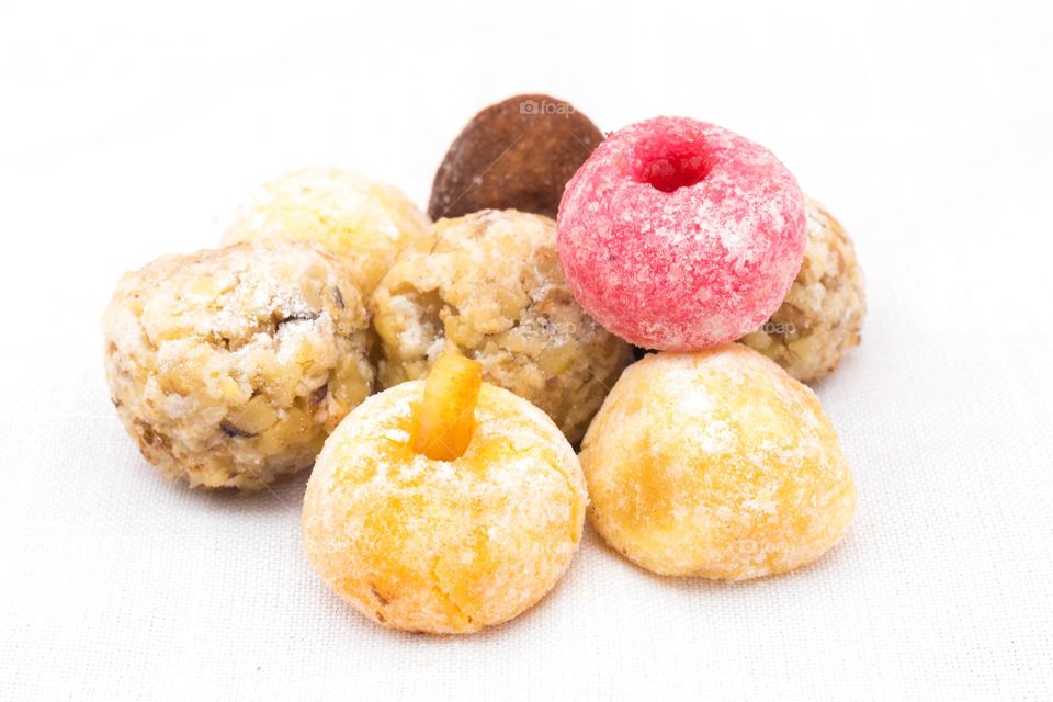 Panellets (traditional sweet for All Saints'Day in Catalonia, the Balearic Islands, Levante and Aragon) on a white tablecloth.