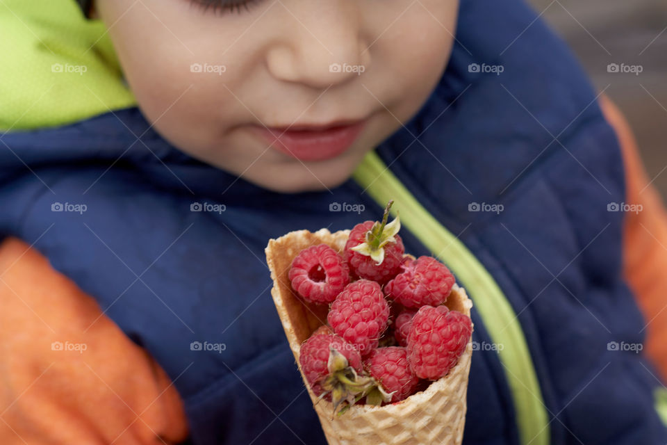 boy eating raspberries