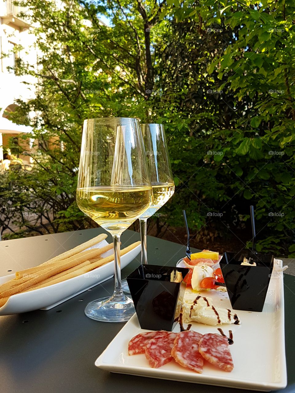 Two glass of white wine with finger food outdoor
