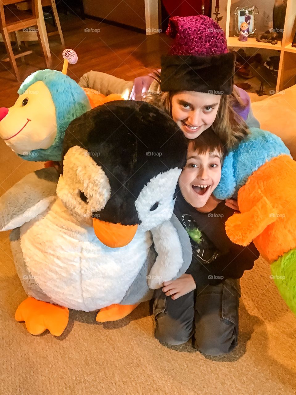 Portrait of sister and brother with soft toys