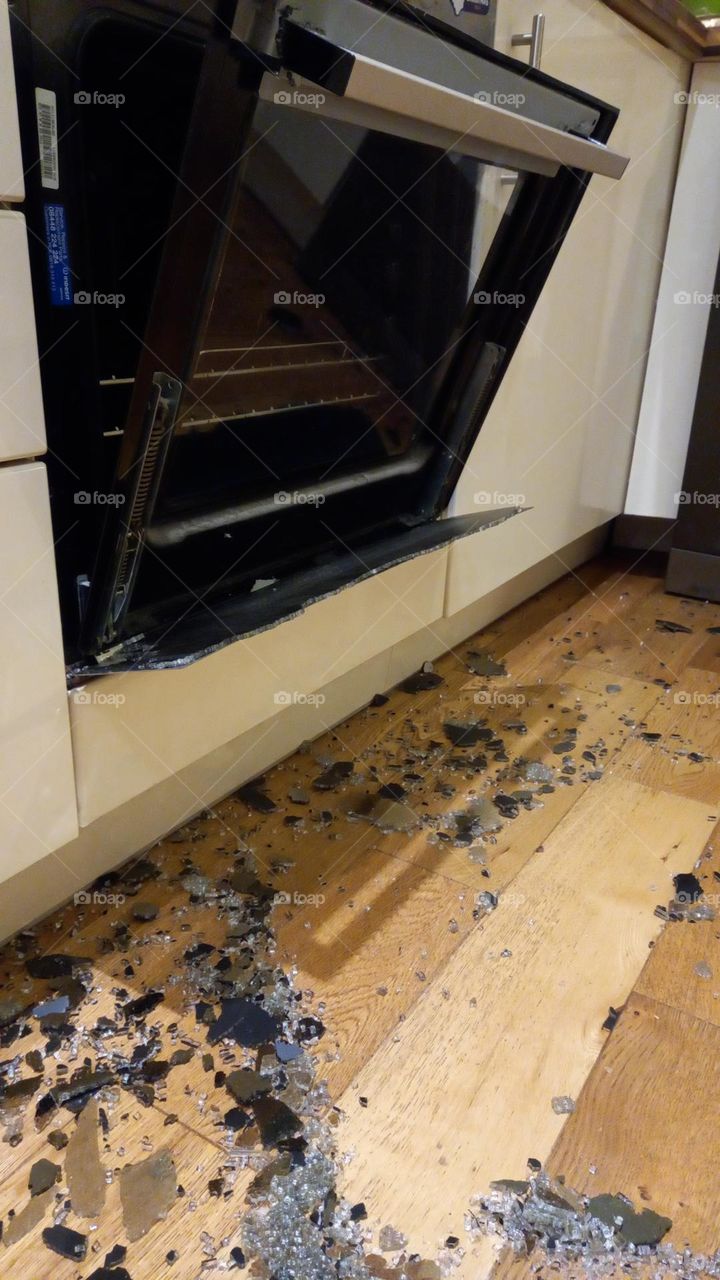 Oven front door explosion. Shattered glass on kitchen floor.